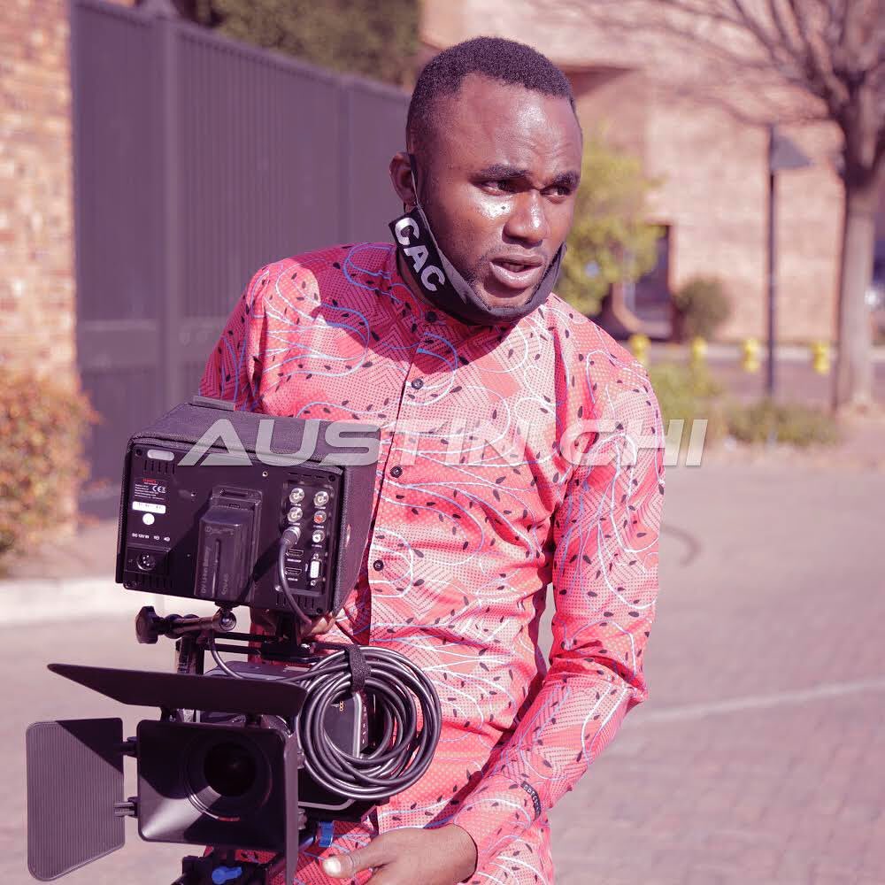 Austine operating a camera in media production